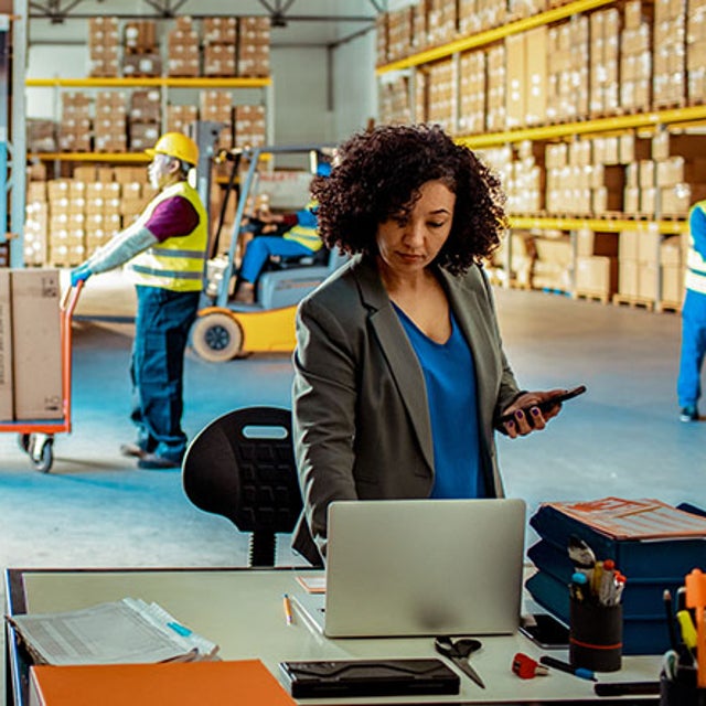 Warehouse manager working on a laptop