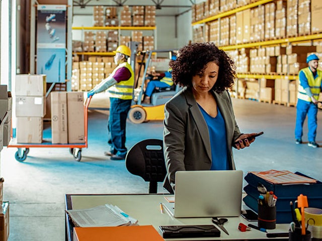 Warehouse manager working on a laptop