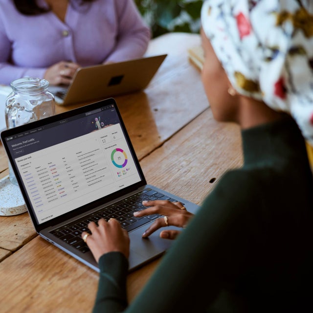 Woman working on a laptop at a coffee shop