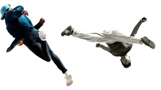 Two males spinning and doing flips in the air