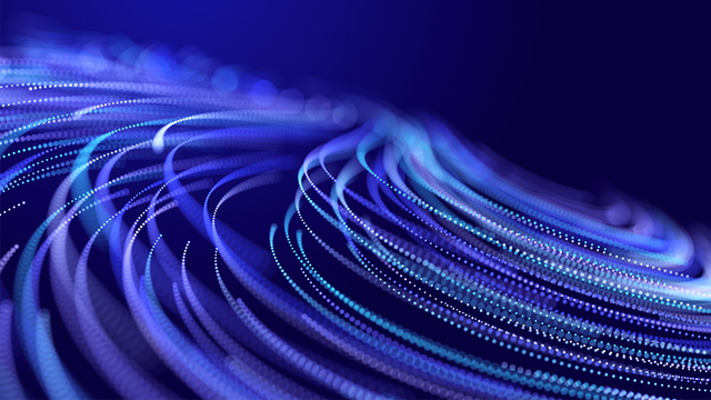 Abstract glitter particles in motion on a purple background