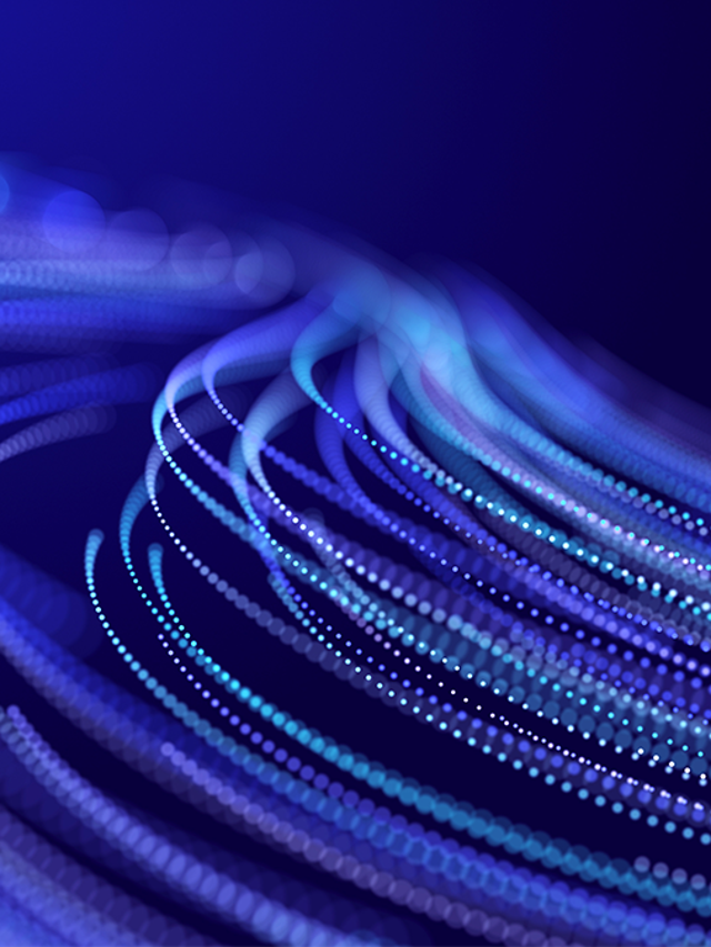 Abstract glitter particles in motion on a purple background