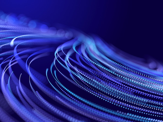 Abstract glitter particles in motion on a purple background