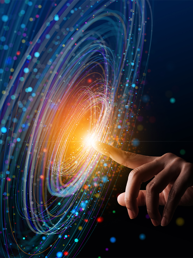 Finger pointing at the bright center of an abstract spiral design