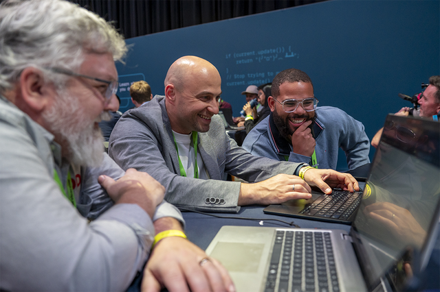 Three men participating in a hackathon
