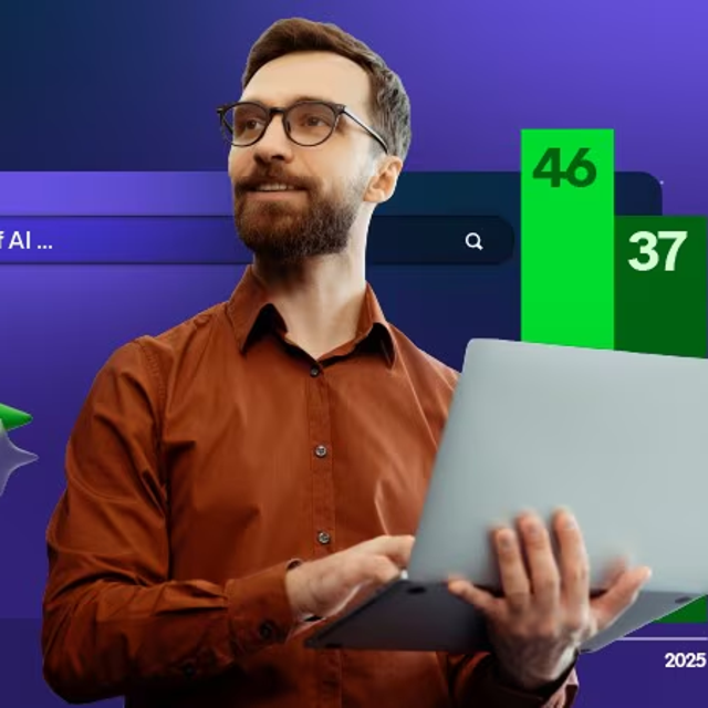 Man holding a laptop in his arms while looking away