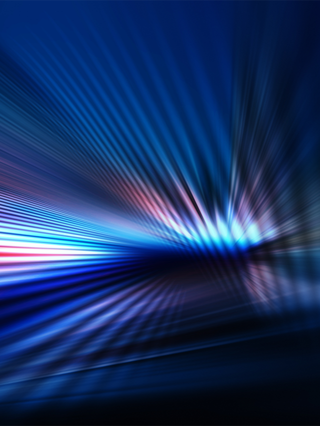 Abstract dark background of light with stripes of colorful rays moving from the center