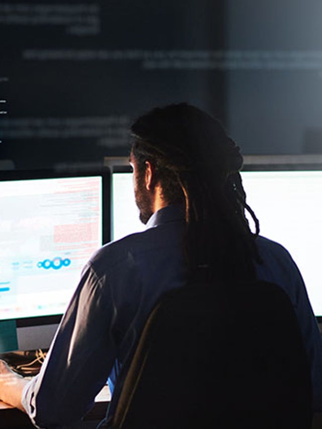 Developer working on a project in a dark office