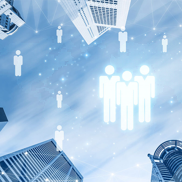 Upward view of a city skyline with glowing person icons