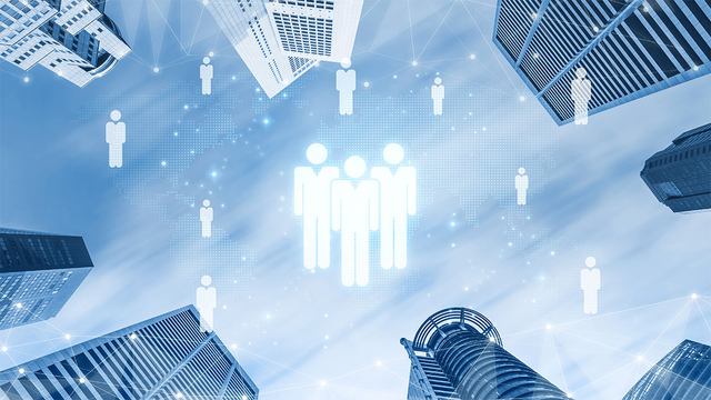 Upward view of a city skyline with glowing person icons