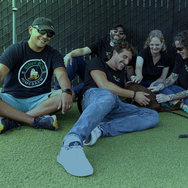 A group of people together with a puppy