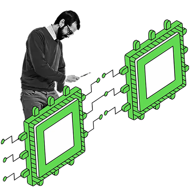 A man inspects two large green circuit board frames connected by a jagged line