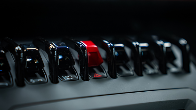 A red switch between black switches