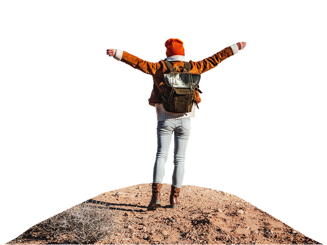 Female standing on top of a hill with excitement