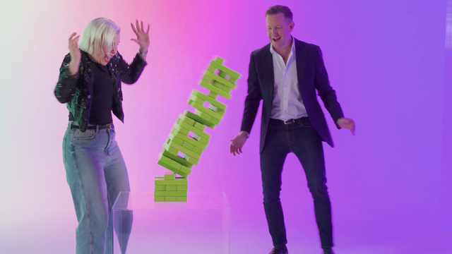 ServiceNow leaders Jayney Howson and Peter McDonnell watching a falling Jenga tower