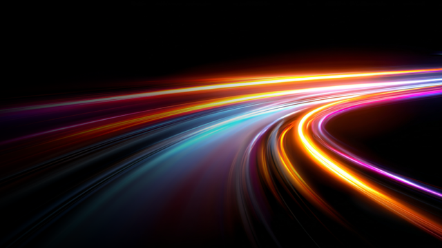 Abstract neon light trails in blue, purple, orange, and magenta curving across a black background