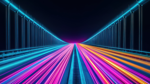 Neon light trails in blue, pink, and orange along a futuristic bridge