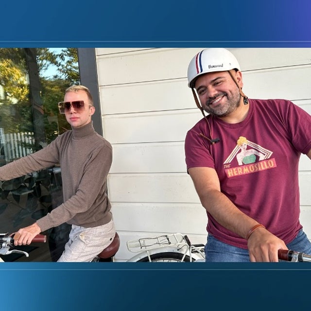 Two ServiceNow employees on bicycles