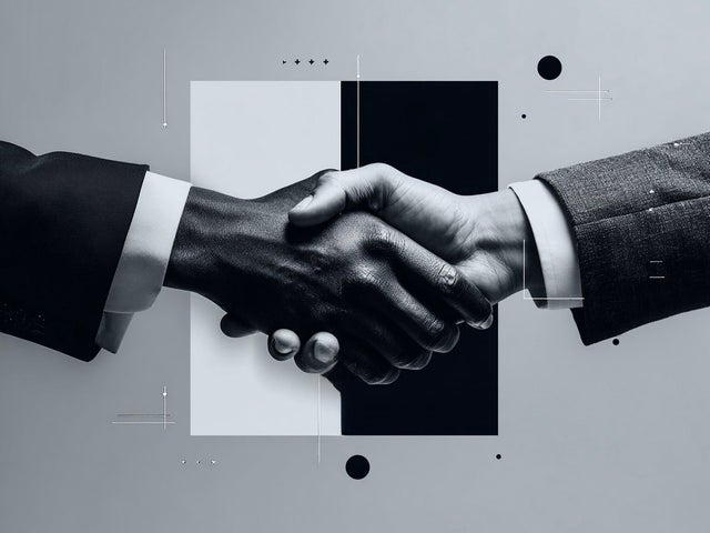 Two hands engaged in a handshake in front of a black and white square