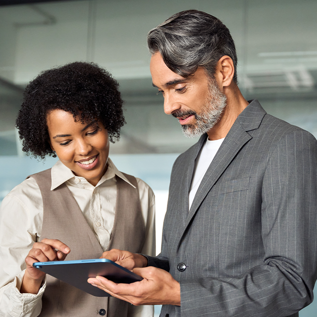 Partner program: two people in an office looking at a tablet together