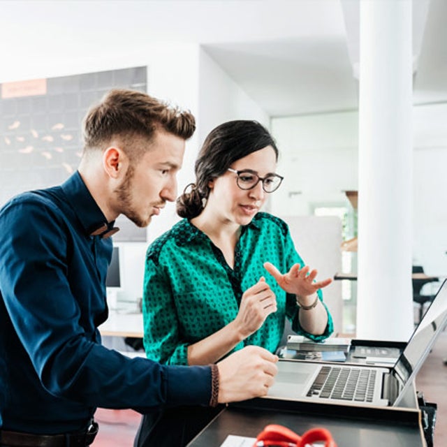 Two workers discussing what’s on a computer screen