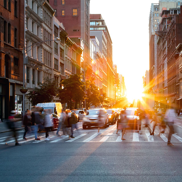 Busy people walking through the intersection of 5th Avenue and 23rd Street in Manhattan, New York City