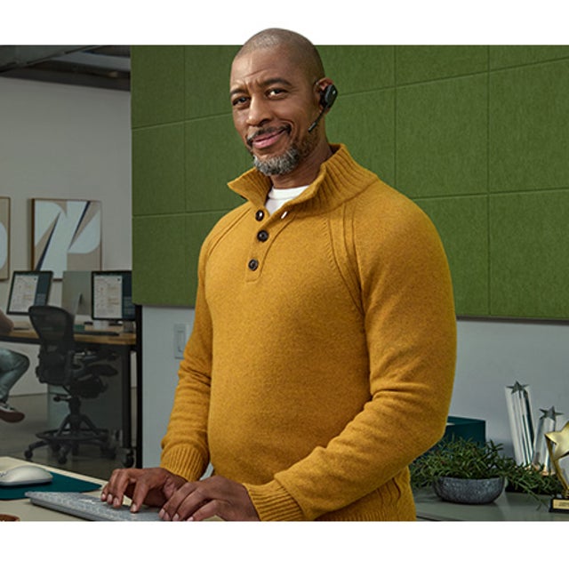 ServiceNow CRM character Jim standing at a desk and typing