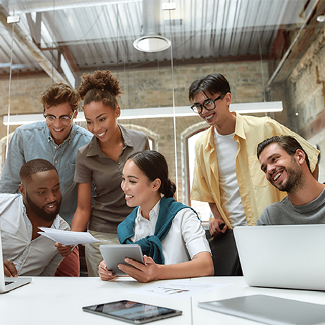 Tech workers interacting in an office thriving amid the rise of AI