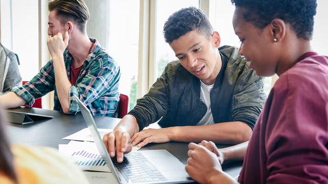 Young people working together on a laptop