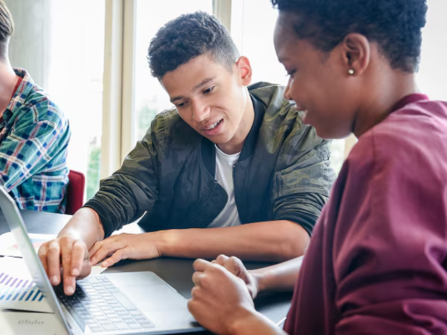 Young people working together on a laptop