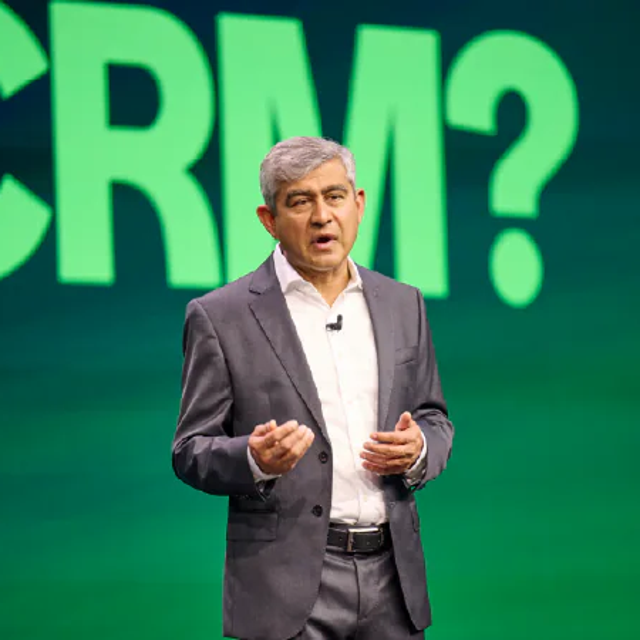 ServiceNow's Amit Zavery standing in front of a screen that says "CRM?"