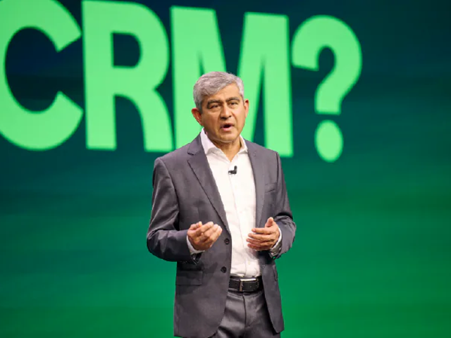 ServiceNow's Amit Zavery standing in front of a screen that says "CRM?"