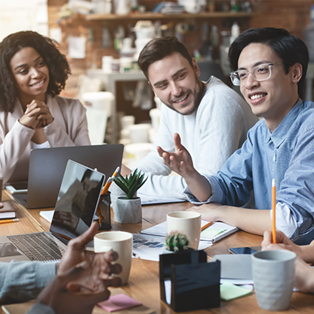 A group of co-workers collaborating around a conference table