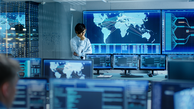 Man standing in a room full of computers