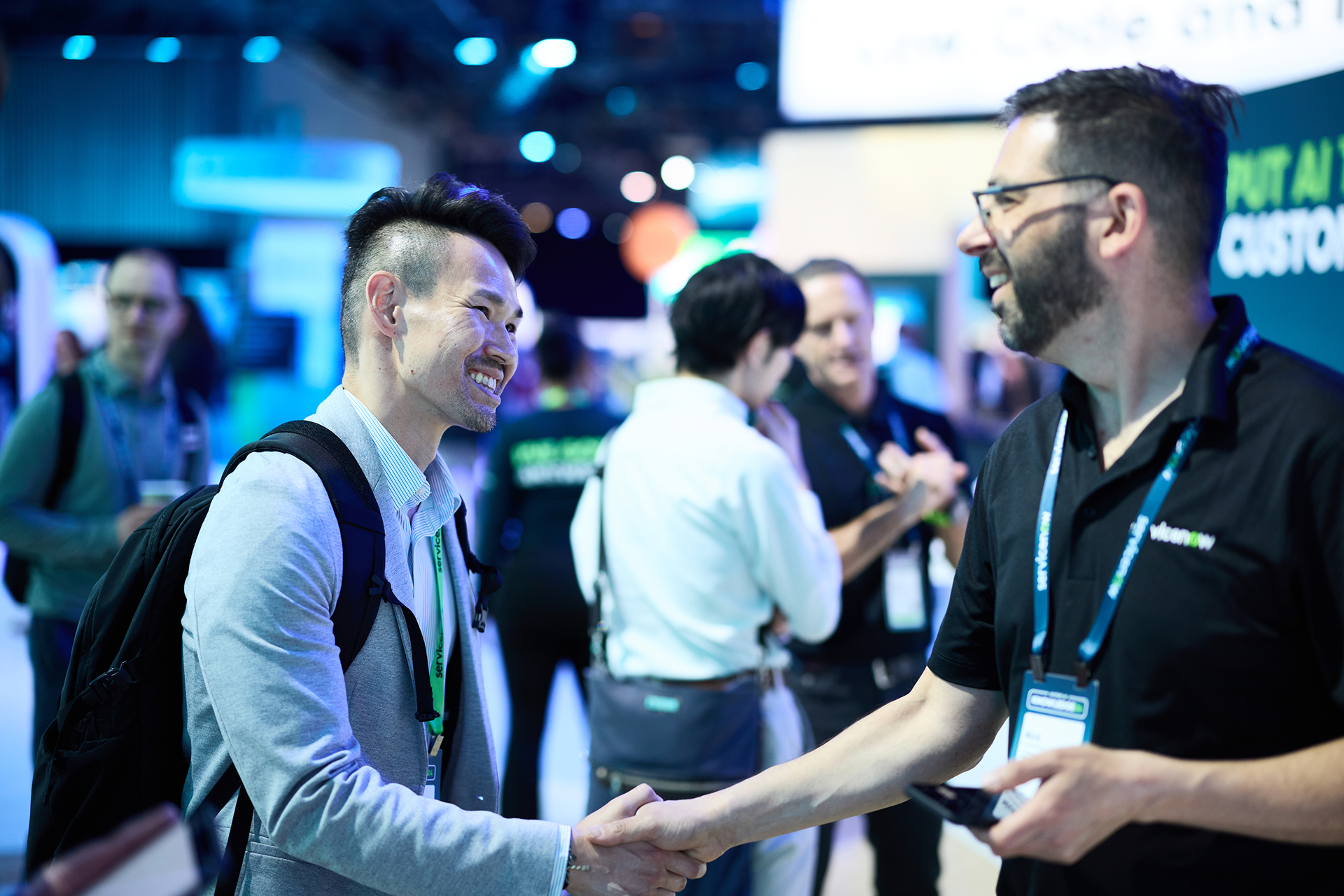 two mens are handshaking hands during event photography