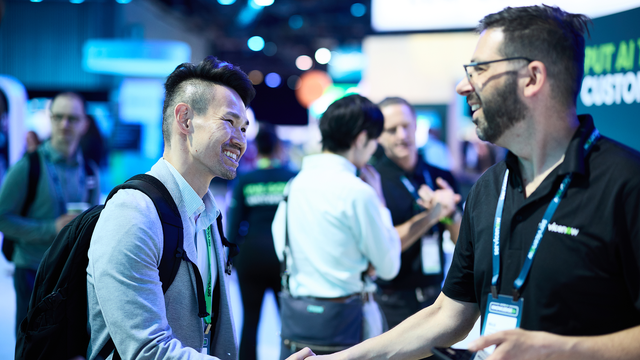 two mens are handshaking hands during event photography