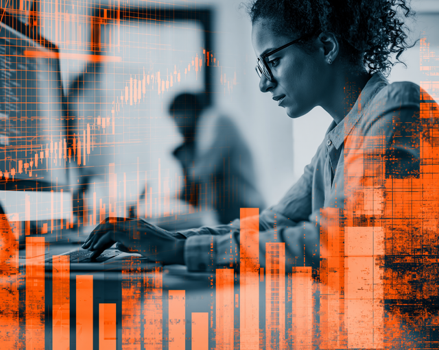 Woman in black and white working on a computer behind an overlay of orange graphs