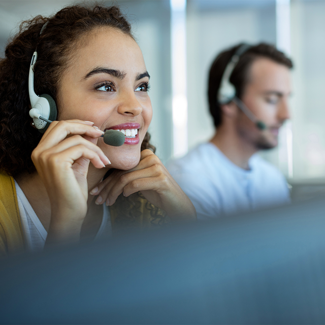 Customer service reps wearing headsets talking to customers