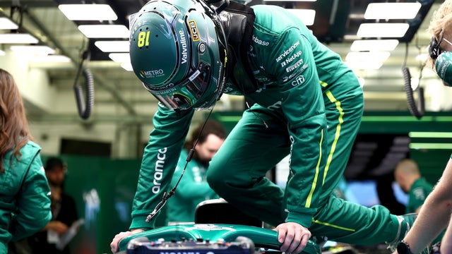 Driver loading into the Aston Martin Aramco Formula One racecar