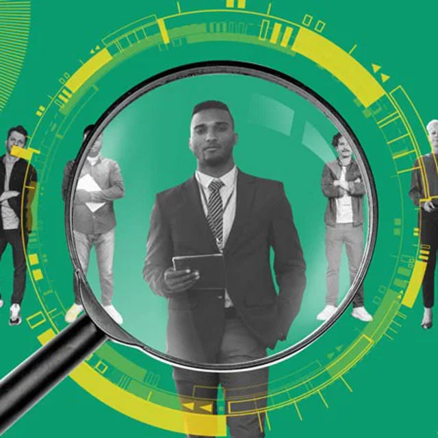 Male behind magnifying glass, with other people in the background