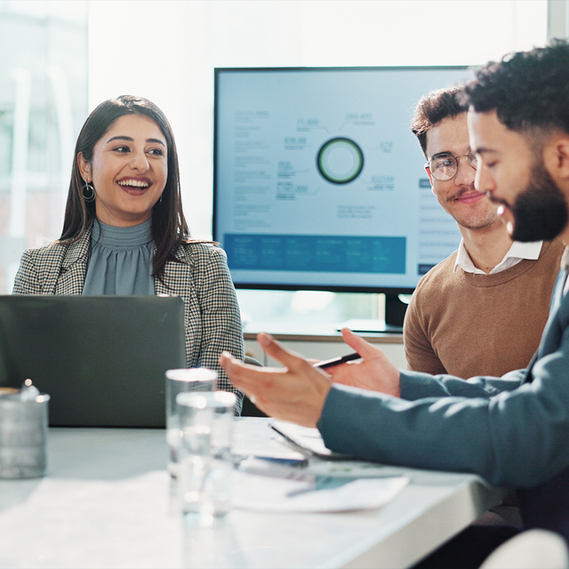 Employees collaborating around a conference table