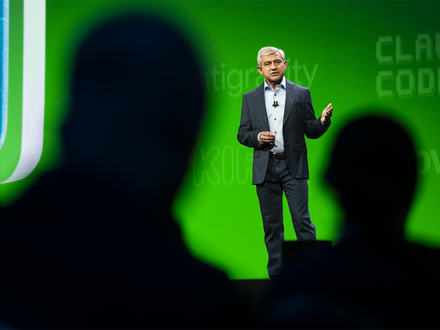 A view of Amit Zavery, ServiceNow president, CPO, and COO, through silhouetted heads 