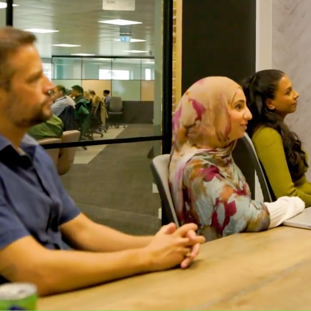 ServiceNow employees sitting at a conference table