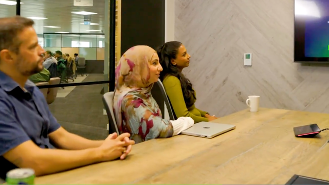 ServiceNow employees sitting at a conference table