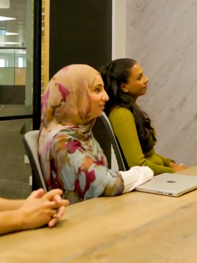 ServiceNow employees sitting at a conference table