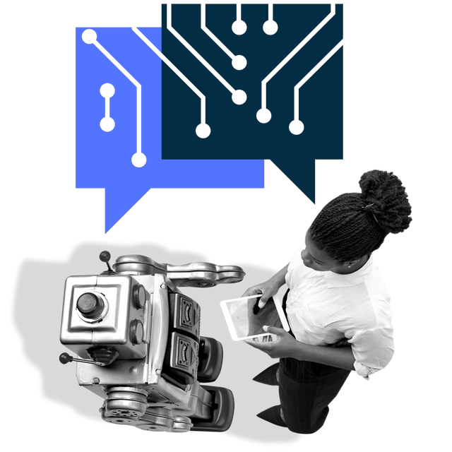 Overhead view of a woman with a laptop across from a small robot