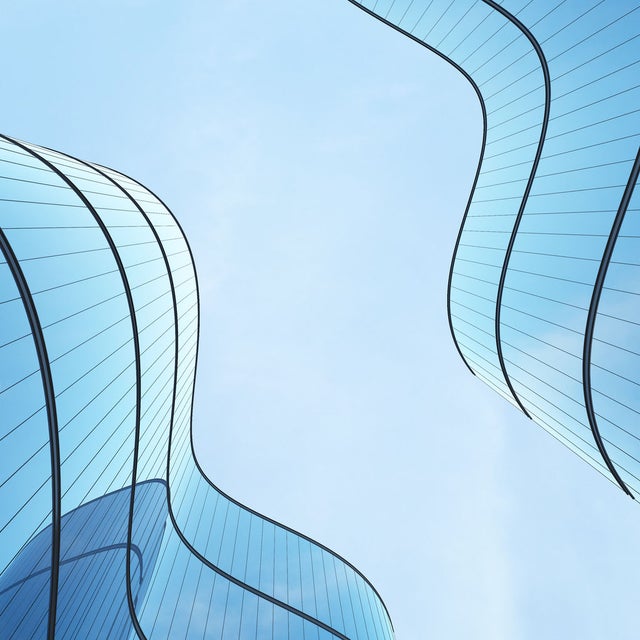 Futuristic architecture: skyscraper office building with curved glass windows