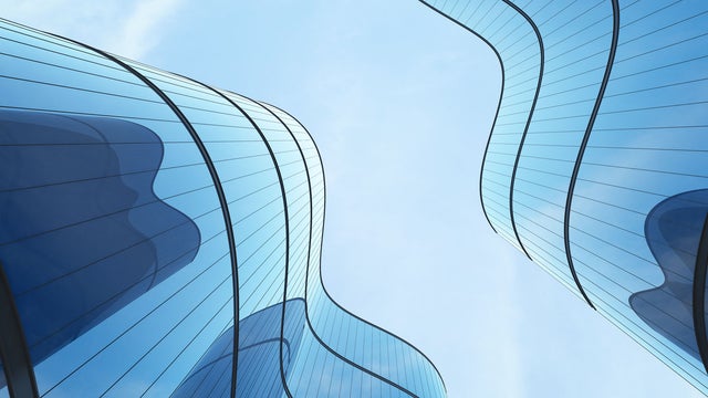 Futuristic architecture: skyscraper office building with curved glass windows