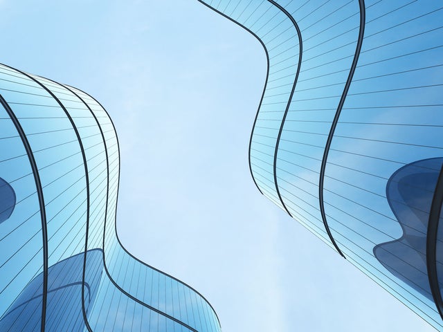 Futuristic architecture: skyscraper office building with curved glass windows