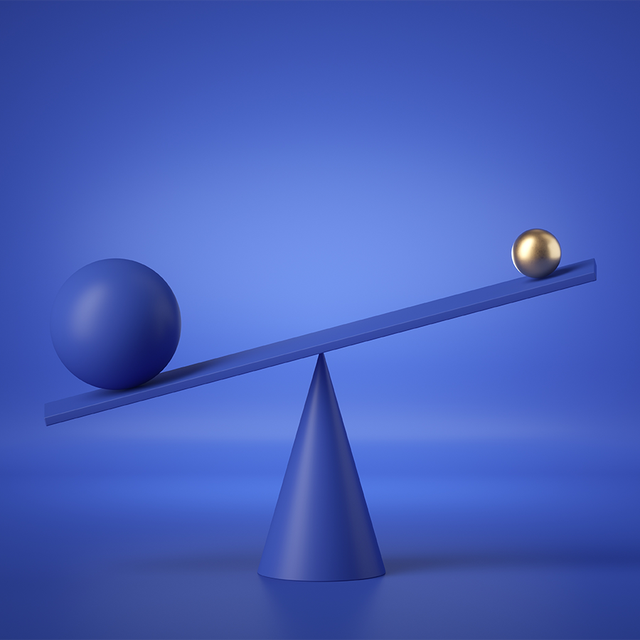 Balancing blue and gold balls on a weighing scale